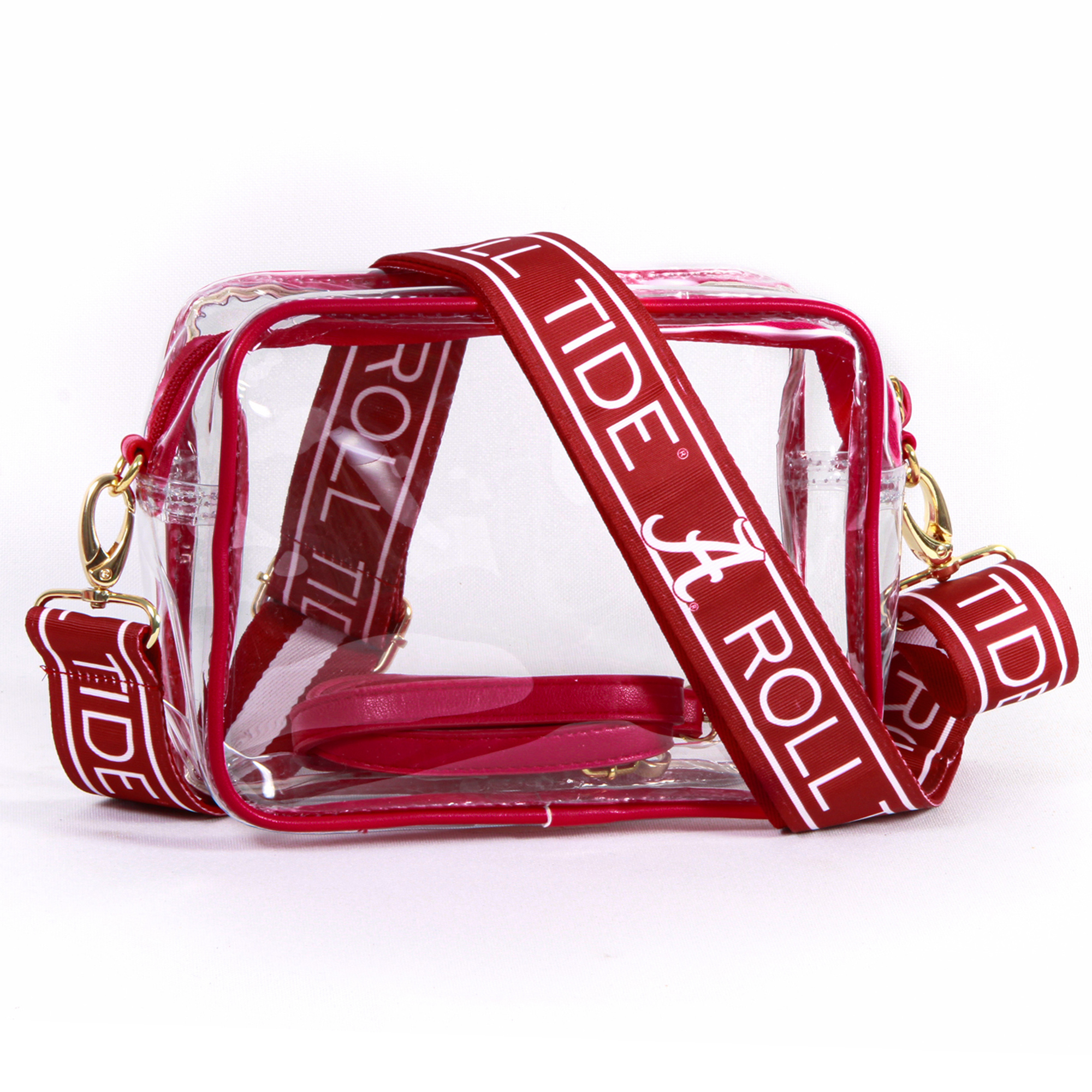 A clear vinyl purse with red vegan leather accents and 'Roll Tide' text on the straps, featuring brass hardware and a zipper closure.