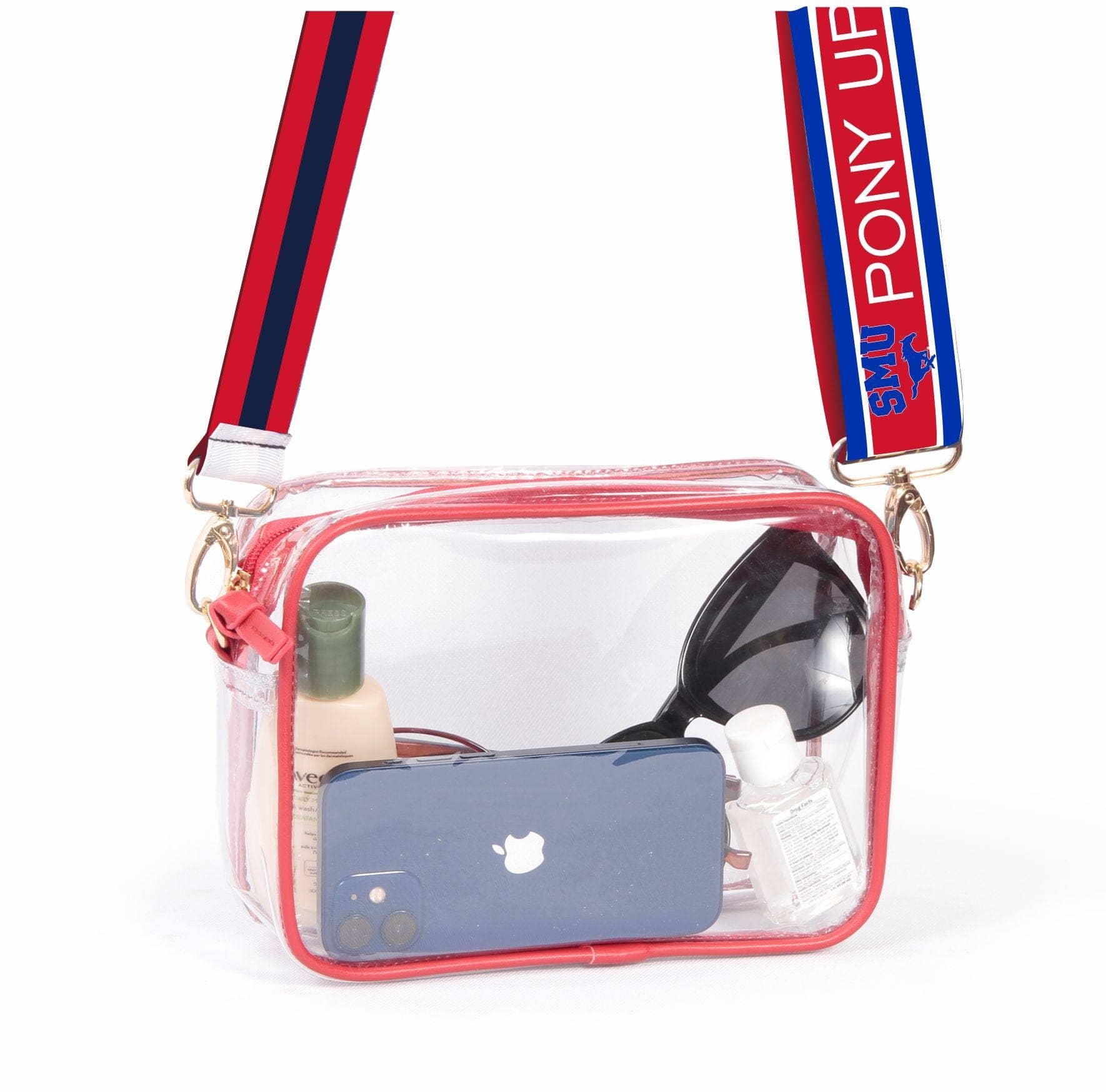 A clear plastic handbag with red vegan leather trim and brass hardware. It includes two shoulder straps, one red and one with a blue and red pattern.